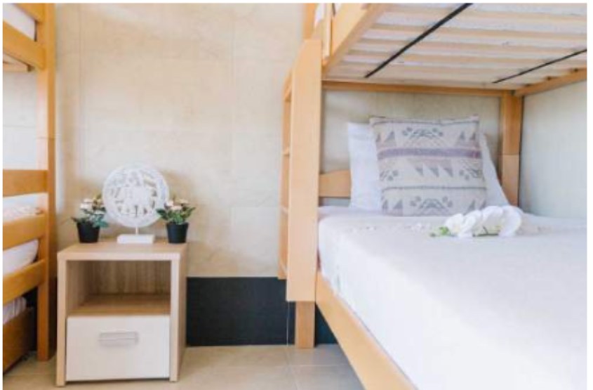 Bunk beds with soft linens in the shared dorm room at Mahakala Center