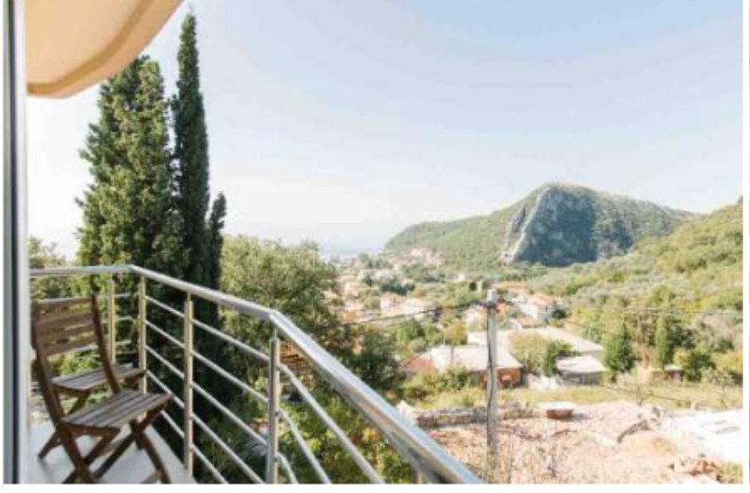 Small dorm balcony with a chair looking out over the hillside village