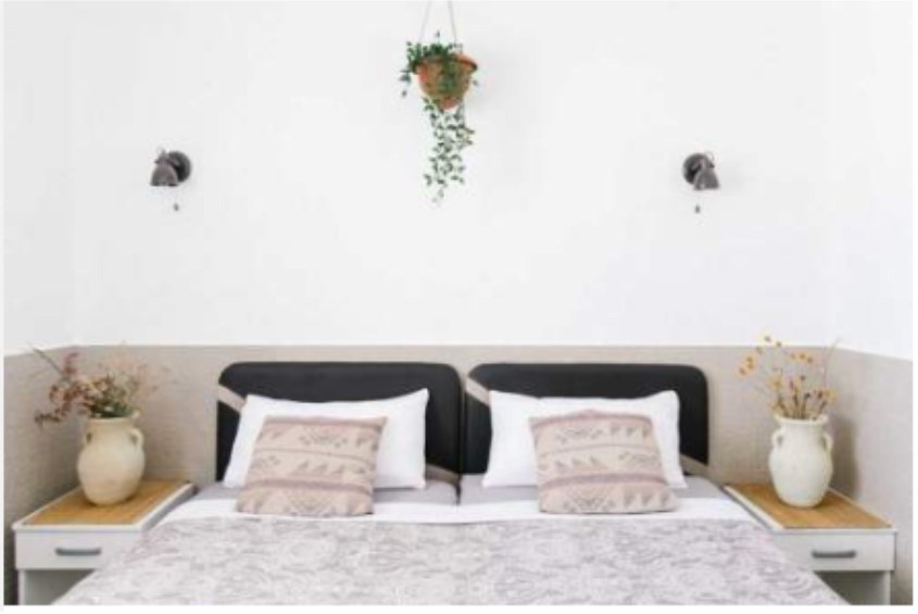 Standard room with twin beds, patterned cushions and ceramic vases