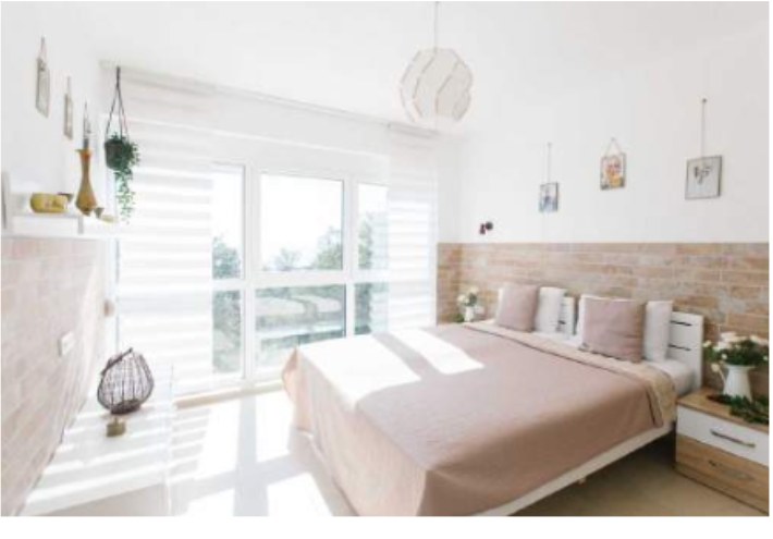 Sun-filled suite with a double bed and a wall of windows to the sea