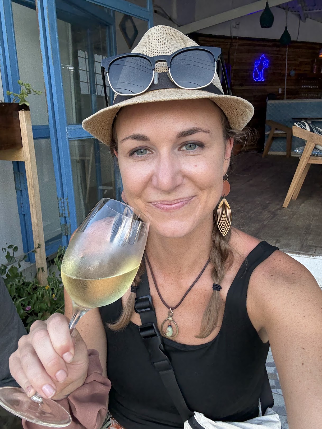 Jaime being poured a glass of red wine in a small local wine bar