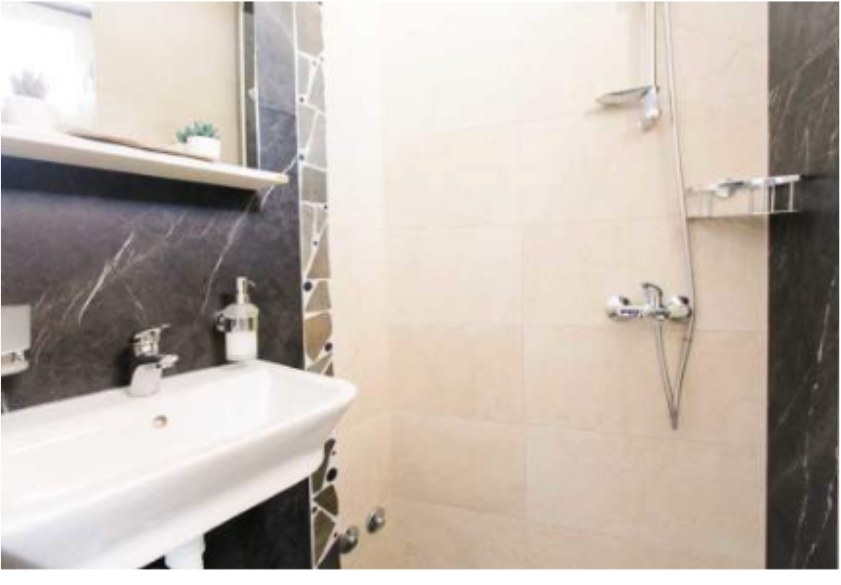 Private bathroom with a walk-in shower and marble detailing